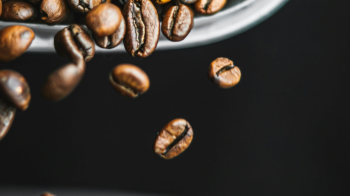 Coffee beans falling from a scoop
