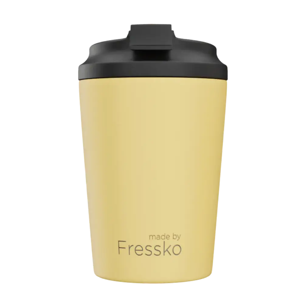 Yellow tumbler with black lid on a white background, branded 'made by Fressko'.