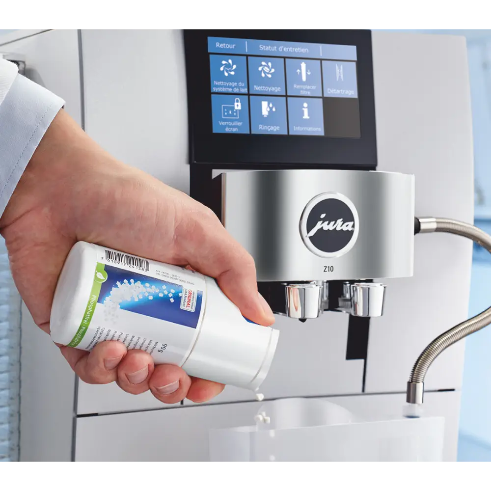 Dispensing minitabs into the Jura coffee machine cleaning container.