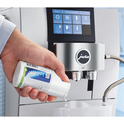 Dispensing minitabs into the Jura coffee machine cleaning container.