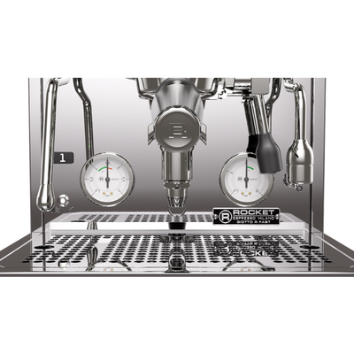 A close-up of a Rocket Commercial Sodo & Fast espresso machine showing the portafilter, steam wands, pressure gauges, drip tray, and water distribution plate.