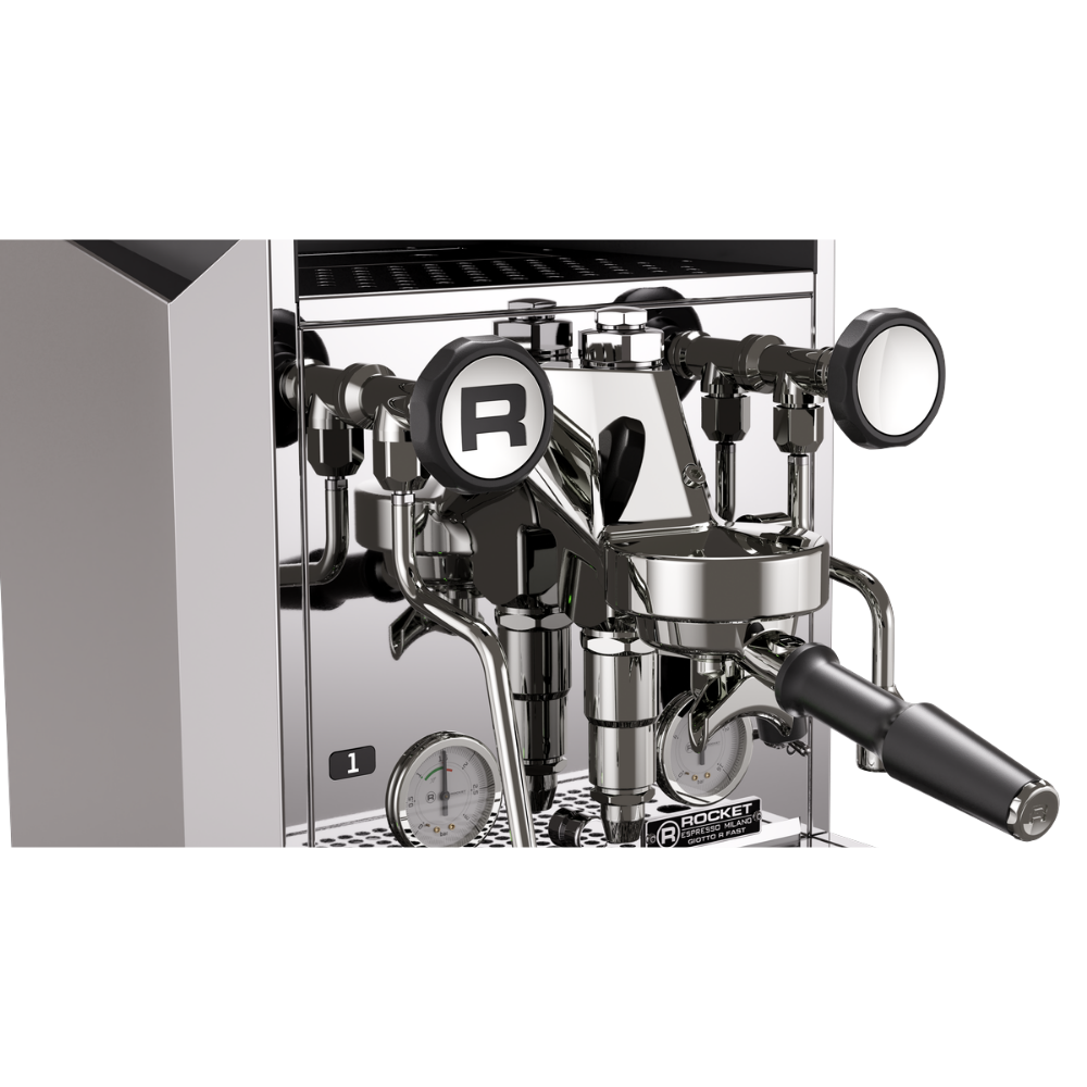 A close-up of a professional espresso machine's steam and milk system, featuring a polished stainless steel portafilter, steam wand, and piping with black accents, set against a clean white background.